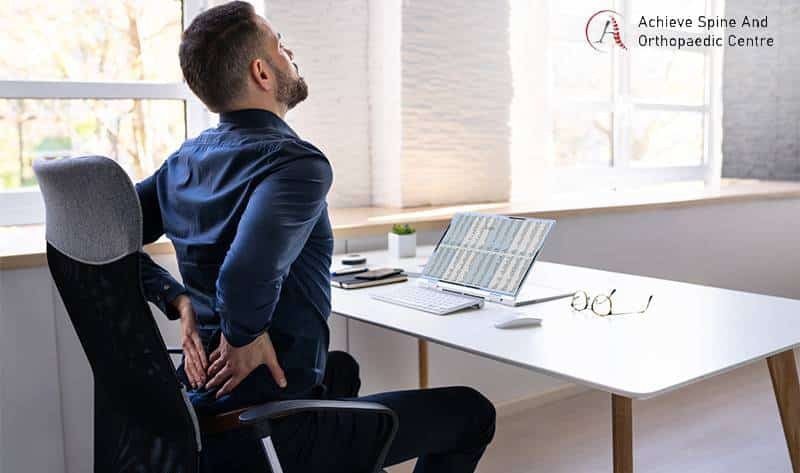 Person holding his spine in pain