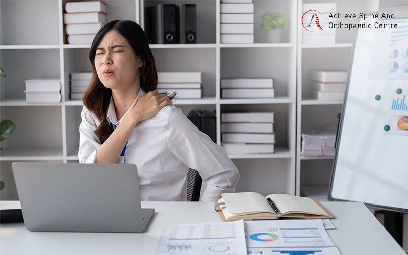 Woman holding her shoulder due to pain