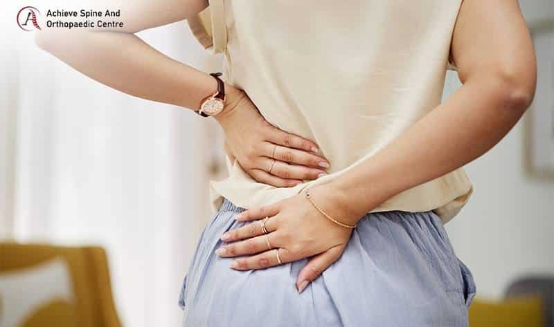 Woman experiencing sharp lower back pain