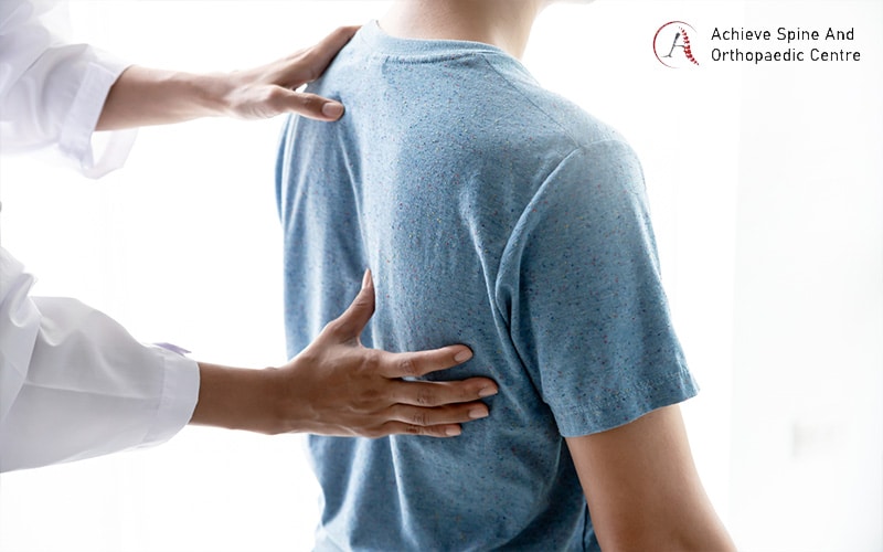 Doctor assessing a patient's back for spinal health treatment