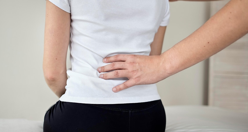 therapist undergoing physical therapy with female patient