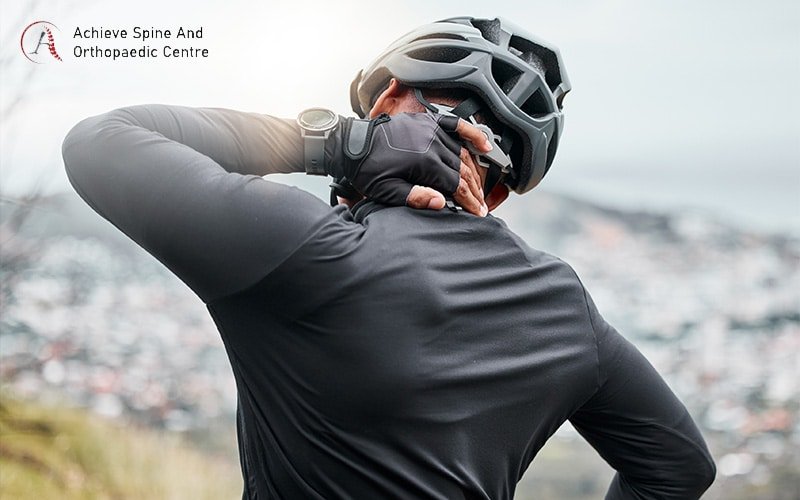 Cyclist holding neck due to pain