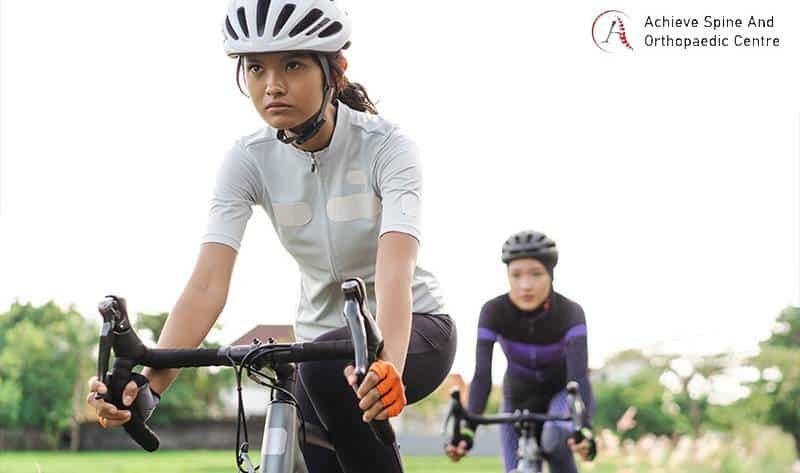 Two women cycling for exercise