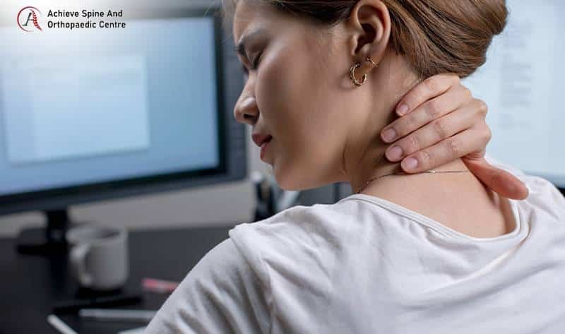 Woman massaging her sore neck from tech neck.