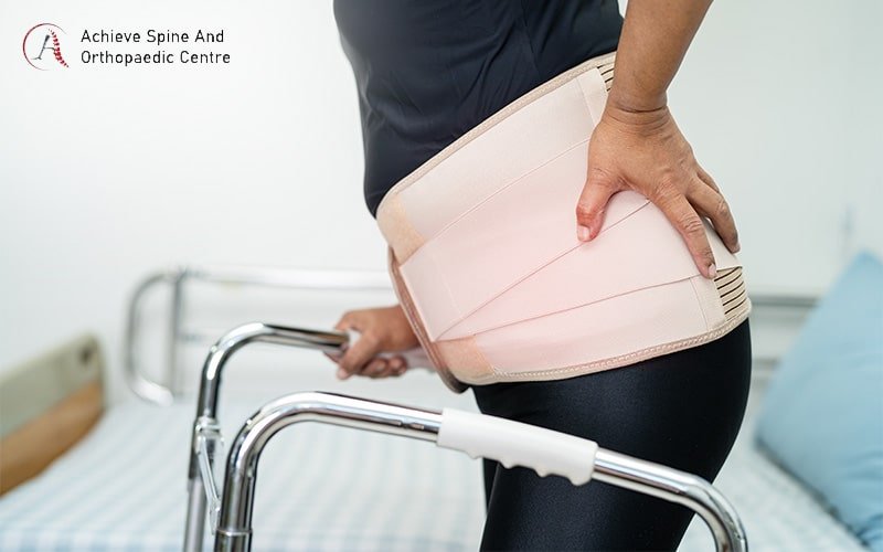 Wearing a lumbar brace for vertebral fracture pain.